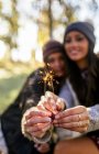 Two women holding sparklers outdoors — Stock Photo