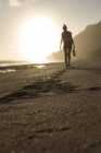 Indonesia, Bali, woman walking on the beach at sunset — Stock Photo