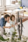 Father and son repairing bicycle together at home — Stock Photo