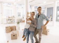 Portrait of happy family moving into new home — Stock Photo