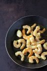 Frying shrimps in pan with oil, garlic and herbs — Stock Photo