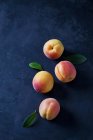 Fresh ripe apricots scattered on black background — Stock Photo