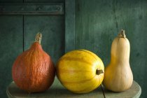Fresh different pumpkins on rustic wooden background — Stock Photo