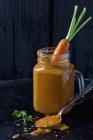 Carrot soup and carrot in a glass — Stock Photo