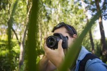 Mann fotografiert mit Kamera im Wald — Stockfoto