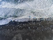 Iceland, Hof, black sand beach with ice pieces — Stock Photo