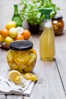 Homemade cleansing agent, vinegar, peels of citrus fruits, ginger and water — Stock Photo