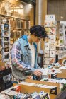 Young man in bookshop — Stock Photo
