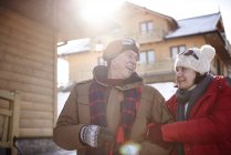 Happy mature couple in mountain village in winter — Stock Photo