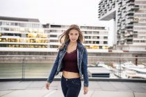 Portrait of attractive young woman at city harbor — Stock Photo