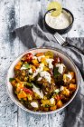 Vegetarian bowl with sweet potato, tomato and falafel, yogurt dip and parsley — Stock Photo
