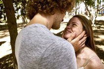 Happy young couple in love in forest — Stock Photo
