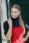 Portrait of smiling young wearing apron — Stock Photo