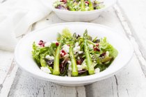Mixed salad with fried green asparagus, feta and pomegranate seeds — Stock Photo