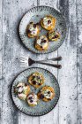Slices of sweet potato with cream cheese, ramson cream, goat cheese, cress and cranberries — Stock Photo