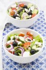 Two bowls of Greek salad on the table — Stock Photo