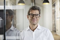 Portrait of smiling businessman wearing glasses — Stock Photo