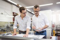 Two businessmen in factory discussing plan — Stock Photo