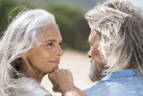 Beautiful senior woman smiling at her husband — Stock Photo