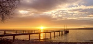 Germany, Baden-Wuerttemberg, Constance, Lake Constance, boardwalk at sunrise — Stock Photo