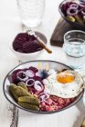 Labskaus, rollmops, pickled gherkin, beetroot salad, onion and fried egg — Stock Photo