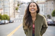 Portrait of laughing young woman on the street — Stock Photo