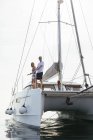 Mature couple making holidays, sailing on a catamaran — Stock Photo