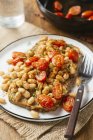 White bean and tomato ragout on toast, white beans, vegetable bouillon powder, Italian herbs, whole grain toast, cherry tomatoes, thyme — Stock Photo