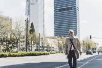 Mature businessman in the city on the go — Stock Photo