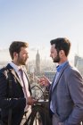 USA, New York City, two businessmen talking on Rockefeller Center observation deck — Stock Photo