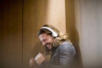 Portrait of excited man listening music with headphones — Stock Photo