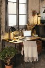 Home office with laptop in a loft — Stock Photo