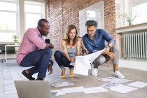 Team of architects discussing the rebuilding of a loft office — Stock Photo