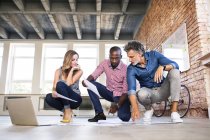 Team of architects discussing the rebuilding of a loft office — Stock Photo