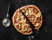 Sliced pizza with frutti di mare on dark ground — Stock Photo