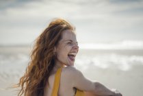Смеющаяся женщина веселится на пляже — стоковое фото