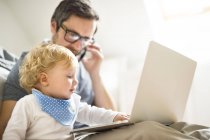 Father with his little son working from home — Stock Photo