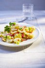 Potato salad with radish on plate — Stock Photo