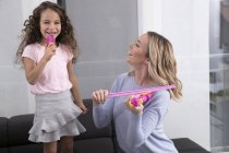 Madre e figlioletta che suonano insieme con il violino giocattolo — Foto stock