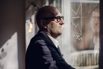 Senior Business Brainstorming, Zeichnen von Formeln auf Fensterscheiben — Stockfoto