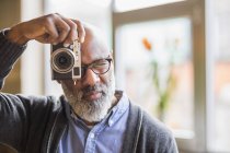 Portrait of african american man taking photo with camera — Stock Photo