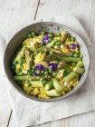 Risotto with green asparagus and peas, garnished with edible flowers — Stock Photo