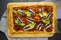 Pizza Marinara garnished with anchovies and parsley — Stock Photo