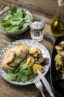 Roasted chicken with potatoes and basil — Stock Photo