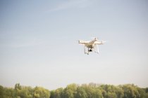 Drone flying in blue sky — Stock Photo