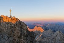 Austria, Germany, Bavaria, Zugspitze, summit cross in the evening light — Stock Photo