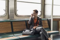 Businesswoman on a ferry on cell phone — Stock Photo