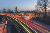 Germany, Hamburg, St. Pauli Landing Stages, Gauge Tower, light trails of trains — Stock Photo