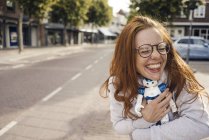 Redheaded woman hugging toy robot — Stock Photo