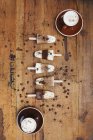 Homemade Espresso Macchiato and Latte Macchiato ice lollies with coffee beans on wooden background — Stock Photo